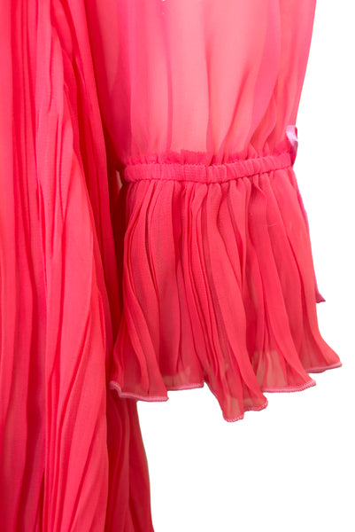 Detail view of new with tags deadstock 2000s vintage y2k coral pink pleated, empire waist, long sleeve chiffon mini baby doll nightgown by Romance for Nk Imode, size large to extra large. Showing the elastic, ruffled, pleated cuff with pink satin bow.