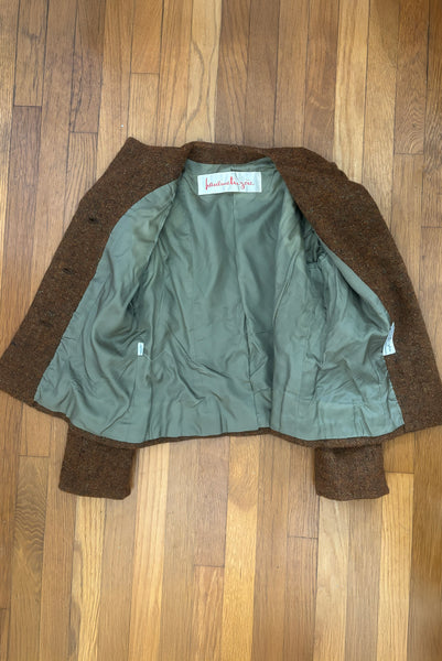 Interior detail view of 1960s vintage rust brown wool, three copper metal button, long sleeve jacket by Pauline Trigère for Bergdorf Goodman, size medium to large. Showing the olive green lining.