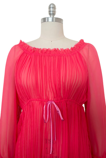 Bodice front view of new with tags deadstock 2000s vintage y2k coral pink pleated, empire waist, long sleeve chiffon mini baby doll nightgown by Romance for Nk Imode, size large to extra large. Showing the round, ruffled elastic neckline and contrasting pink satin drawstring at the empire waistline.