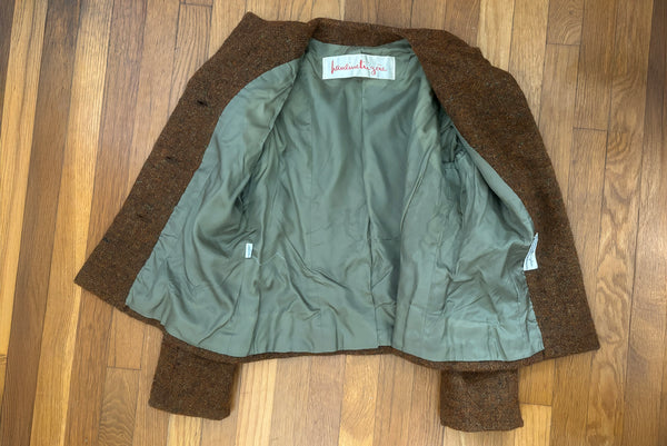 Interior detail view of 1960s vintage rust brown wool, three copper metal button, long sleeve jacket by Pauline Trigère for Bergdorf Goodman, size medium to large. Showing the olive green lining.
