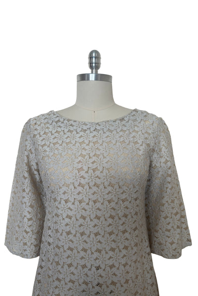 Bodice front view of 1960s vintage white and beige floral lace shift dress, size medium to large.