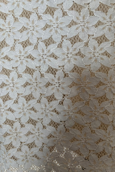 Detail view of 1960s vintage white and beige floral lace shift dress, size medium to large. Showing a close-up of the beige and white corded lace.