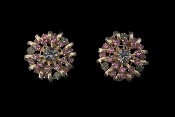 Horizontal earring front view of 1950s vintage pink & gray round and pear cut rhinestone gold tone necklace and earrings demi-parure jewelry set. Showing a close-up of the large round clip-on earrings.