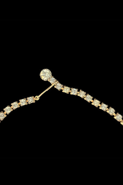 Detail front view of 1950s vintage pink & gray round and pear cut rhinestone gold tone necklace and earrings demi-parure jewelry set. Showing a close-up of the necklace hook closure.