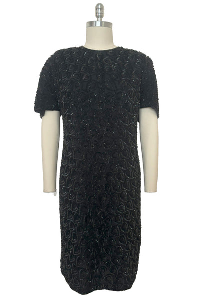 Front view of 1990s black sequin leaf pattern beaded cocktail dress, large to extra large.