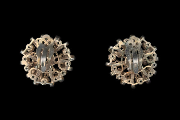 Horizontal earring back view of 1950s vintage pink & gray round and pear cut rhinestone gold tone necklace and earrings demi-parure jewelry set. Showing a close-up of the large round clip-on earrings.