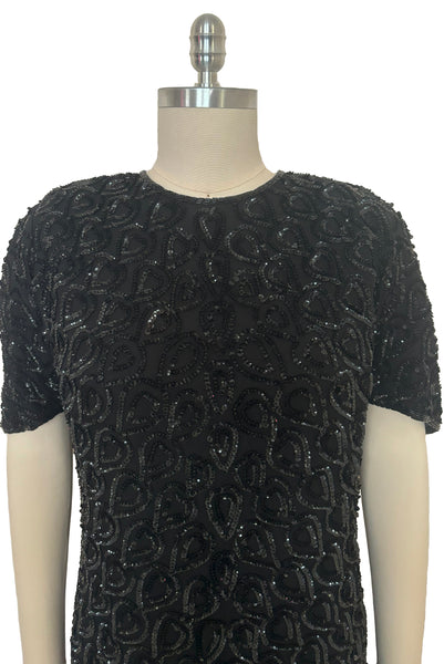 Bodice front view of 1990s black sequin leaf pattern beaded cocktail dress, large to extra large. Showing the sequin details.