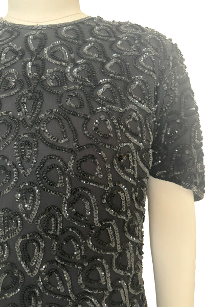 Bodice front detail view of 1990s black sequin leaf pattern beaded cocktail dress, large to extra large. Showing the sequin leaf pattern detail.
