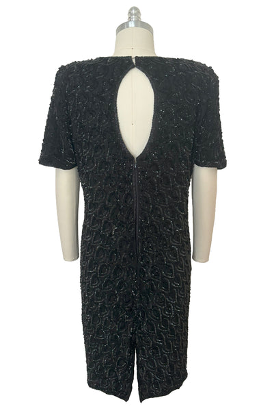 Back view of 1990s black sequin leaf pattern beaded cocktail dress, large to extra large. Showing the keyhole back and zipper closure.