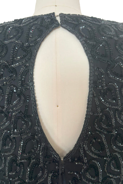Back detail view of 1990s black sequin leaf pattern beaded cocktail dress, large to extra large. Showing the black glass bugle beads around the keyhole back and leaf sequin pattern.