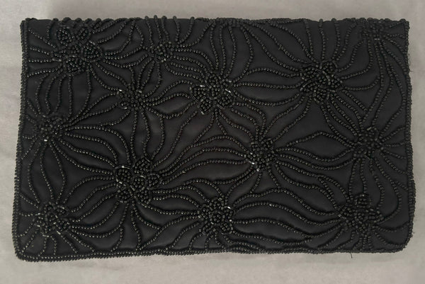 Horizontal back view of 1960s vintage black satin floral beaded fold over clutch evening bag by Walborg.