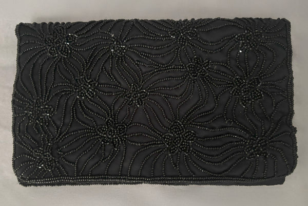 Horizontal front view of 1960s vintage black satin floral beaded fold over clutch evening bag by Walborg.