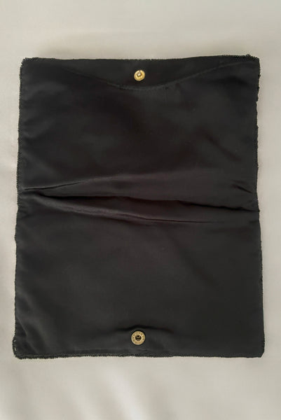 Vertical interior view of 1960s vintage black satin floral beaded fold over clutch evening bag by Walborg.