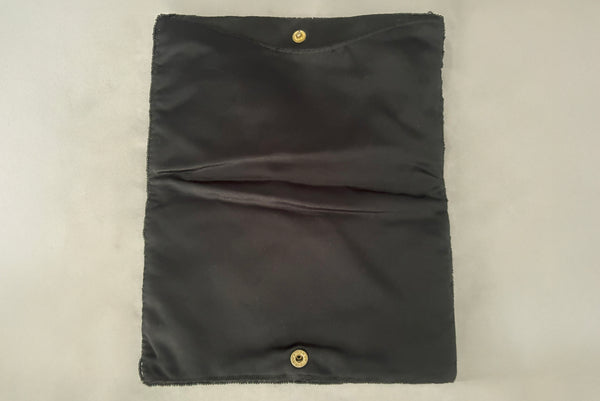 Horizontal interior view of 1960s vintage black satin floral beaded fold over clutch evening bag by Walborg.