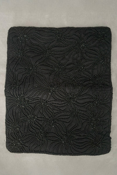 Vertical open view of 1960s vintage black satin floral beaded fold over clutch evening bag by Walborg.