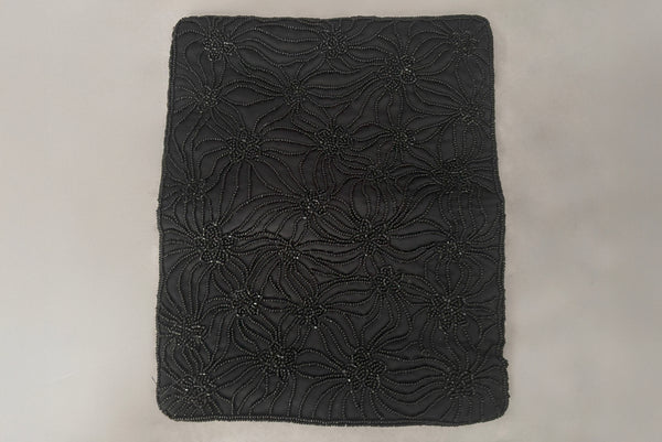 Horizontal open view of 1960s vintage black satin floral beaded fold over clutch evening bag by Walborg.