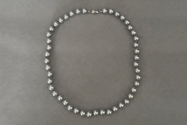 Horizontal view of 1980s vintage designer gray faux pearl bead necklace, by Monet.