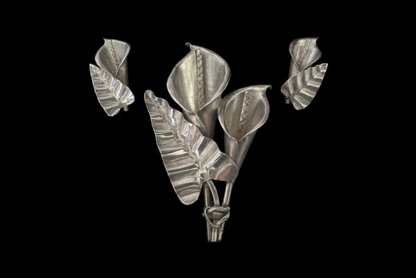 Horizontal front view of 1950s vintage Mexican silver calla lily engraved floral brooch and screw back earrings jewelry set.