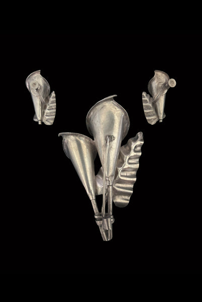 Vertical back view of 1950s vintage Mexican silver calla lily engraved floral brooch and screw back earrings jewelry set.