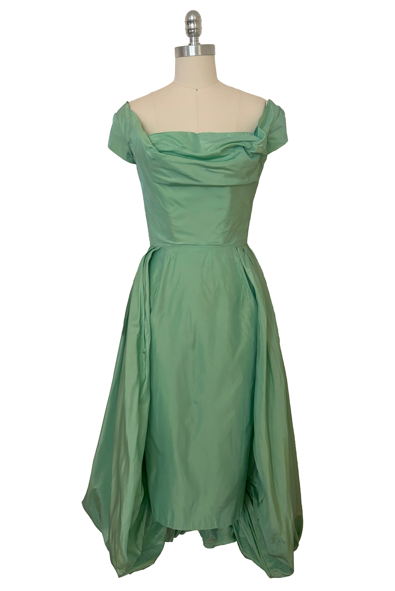 Front view of 1950s vintage mint green iridescent taffeta shelf bust wiggle cocktail dress with balloon train by Kay Selig, extra extra small to extra small.