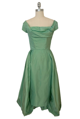 Front view of 1950s vintage mint green iridescent taffeta shelf bust wiggle cocktail dress with balloon train by Kay Selig, extra extra small to extra small.