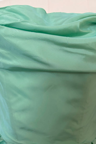 Bodice detail view of 1950s vintage mint green iridescent taffeta shelf bust wiggle cocktail dress with balloon train by Kay Selig, extra extra small to extra small. Showing a small spot on the self bust.