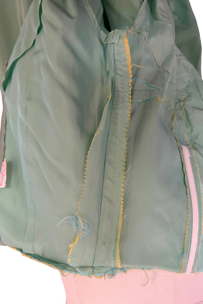 Interior detail view of 1950s vintage mint green iridescent taffeta shelf bust wiggle cocktail dress with balloon train by Kay Selig, extra extra small to extra small. Showing the seam allowances and that the dress has been taken in.
