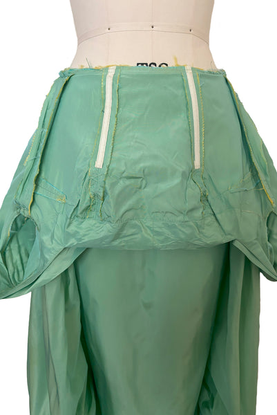 Interior detail view of 1950s vintage mint green iridescent taffeta shelf bust wiggle cocktail dress with balloon train by Kay Selig, extra extra small to extra small. Showing the boning and interior of the shelf bust.