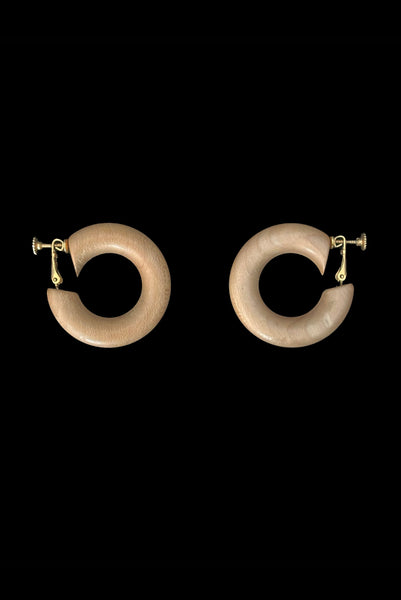 Vertical side view of 1980s vintage blonde and dark brown two tone wood hoop clip-on adjustable earrings.