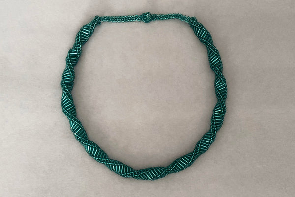 Horizontal view of 1980s vintage teal glass seed and bugle bead twisted beadwork necklace.
