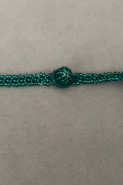 Detail view of 1980s vintage teal glass seed and bugle bead twisted beadwork necklace. Showing a close-up of the beaded clasp.