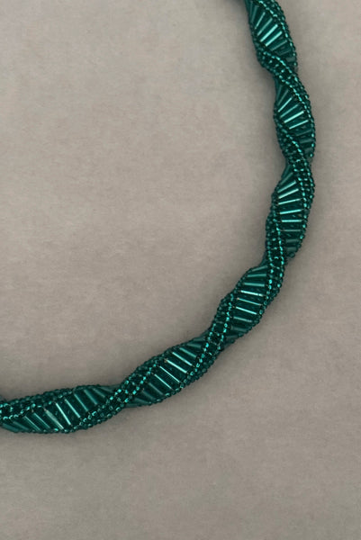 Detail view of 1980s vintage teal glass seed and bugle bead twisted beadwork necklace.