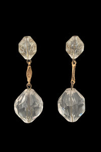 Vertical front view of 1960s vintage mod clear faceted Lucite bead and gold tone metal top and drop clip-on earrings.