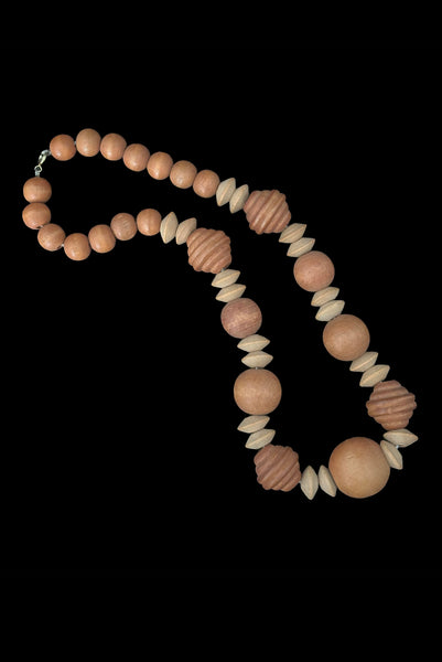 Vertical view of 1980s vintage light and medium carved wood round, ridged bicone, and disk bead graduated two tone necklace.