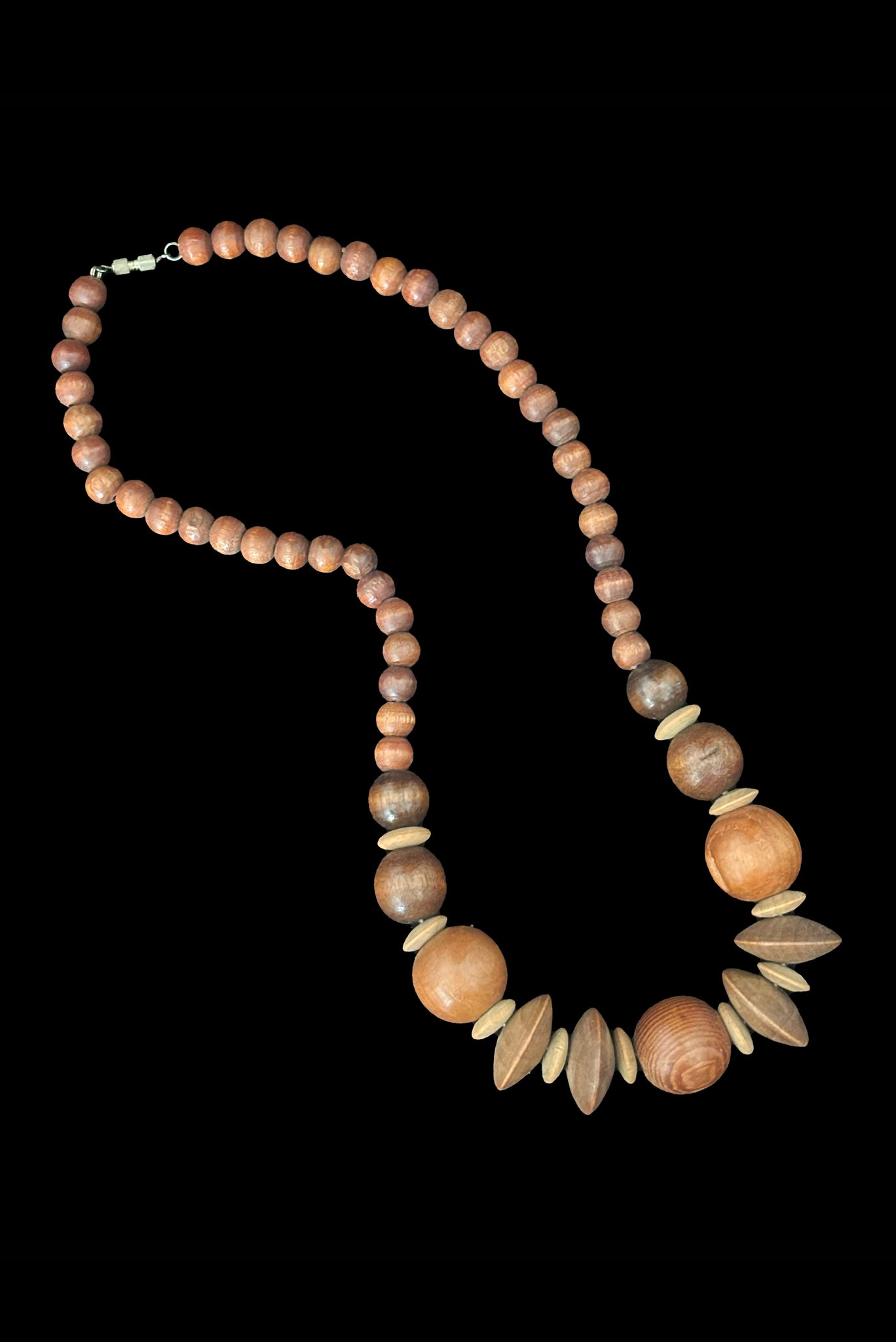 Vertical view of 1980s vintage carved round and disk bead light, medium, and dark triple tone wood necklace.