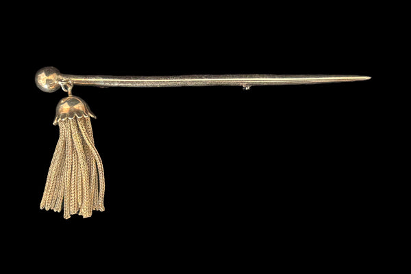 Horizontal front view of 1960s vintage gold tone bar brooch with metal mesh tassel.