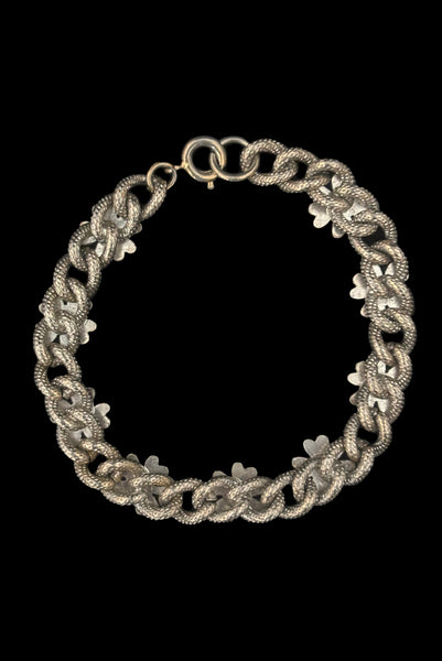 Vertical back view of 1960s vintage champagne gold tone four leaf clover lucky charm link bracelet.