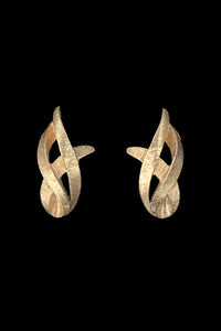 Vertical front view of 1960s vintage brushed gold tone flame clip-on earrings by Monet.