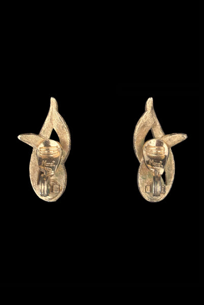 Vertical back view of 1960s vintage brushed gold tone flame clip-on earrings by Monet.
