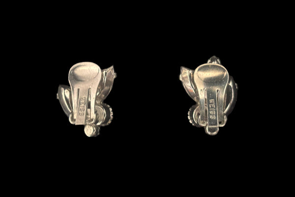 Horizontal back view of 1950s vintage blue and iridescent, round and marquise rhinestone and silver tone clip-on earrings by Weiss.