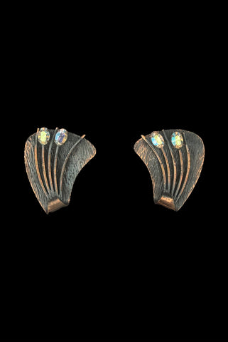Vertical front view of 1960s vintage darkened copper and iridescent marquise rhinestone botanical cattail clip-on earrings.
