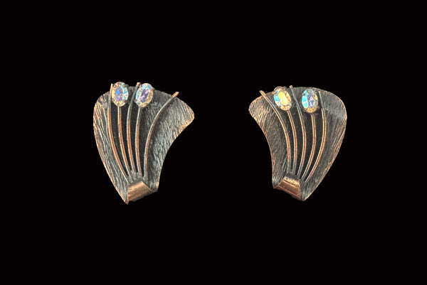 Horizontal front view of 1960s vintage darkened copper and iridescent marquise rhinestone botanical cattail clip-on earrings.
