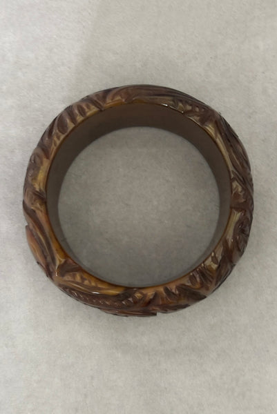 Vertical top view of 1930s vintage novelty octopus sea life carved green Bakelite statement bangle bracelet.