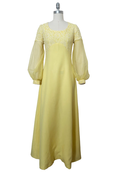 Front view of 1960s vintage yellow crepe and lace empire waist maxi dress with chiffon bishop sleeves, size extra small to small.
