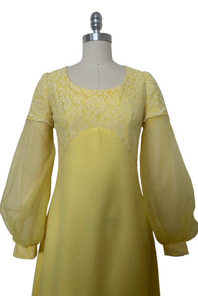 Bodice front view of 1960s vintage yellow crepe and lace empire waist maxi dress with chiffon bishop sleeves, size extra small to small.