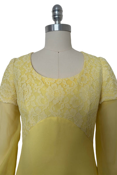 Bodice front view of 1960s vintage yellow crepe and lace empire waist maxi dress with chiffon bishop sleeves, size extra small to small. Showing the lace overlay to the empire waist bodice and sleeve caps.