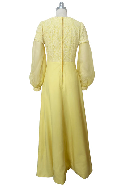 Back view of 1960s vintage yellow crepe and lace empire waist maxi dress with chiffon bishop sleeves, size extra small to small.