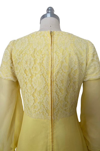 Bodice back view of 1960s vintage yellow crepe and lace empire waist maxi dress with chiffon bishop sleeves, size extra small to small. Showing the lace overlay to the empire waist bodice and sleeve caps.