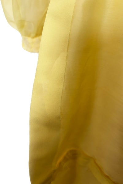 Interior detail view of 1960s vintage yellow crepe and lace empire waist maxi dress with chiffon bishop sleeves, size extra small to small. Showing the fused hem.