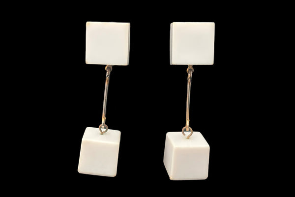 Horizontal front view of 1960s vintage Mod gold tone and white Lucite cube bead top and drop clip-on dangle earrings.